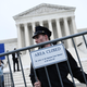 Police officers set up barricades as demonstrators gather in front of the Supreme Court in May.